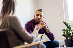 Man listens intently after learning tips on finding a good therapist