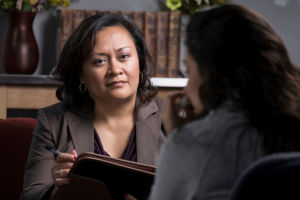 Therapist listens to person talk during one on one therapy session