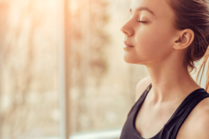 Women inhales while practicing mindfulness