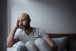 Man sits on couch and struggles with his major depressive disorder