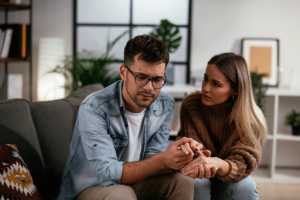 Woman holds hands with partner as they discuss anxiety and relationships