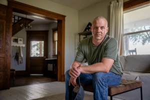 Veteran sits and poses as he talks about national PTSD awareness day