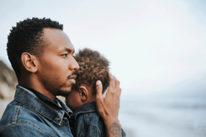 Man cradles baby's head and wonders if ADHD is genetic