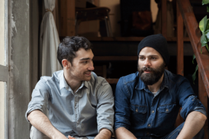 Two men sit and chat about their loved one who is hiding depression