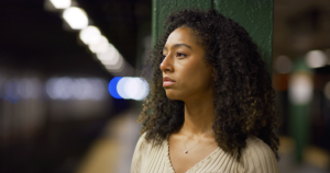 Woman stands in subway as she copes with PTSD triggers