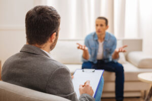 Man talks to therapist about benefits of depression therapy