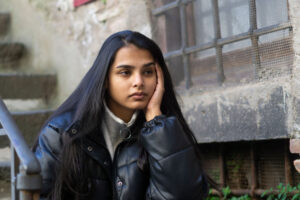 Woman sits on stoop and considers effective treatment options for severe depression