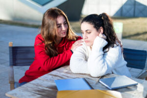 Woman tries to console friend as they talk about overcoming mental health stigma