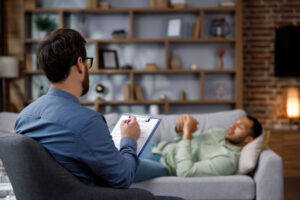 Man lays on couch and talks to therapist and learning how to prepare for first therapy session
