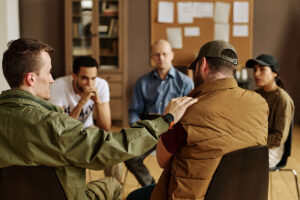 a group of people sit together and discuss post-traumatic stress disorder and their loved ones