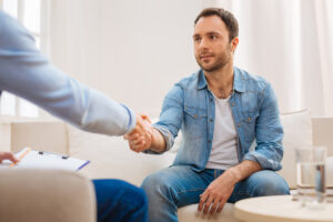 Man shaking a psychiatrist's hand