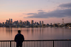 Man looking out at Seattle skyline