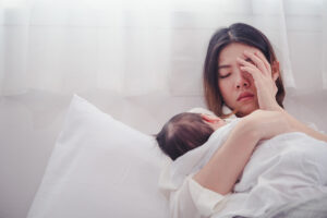 Tired Mother Suffering from experiencing postnatal depression.Health care single mom motherhood stressful.